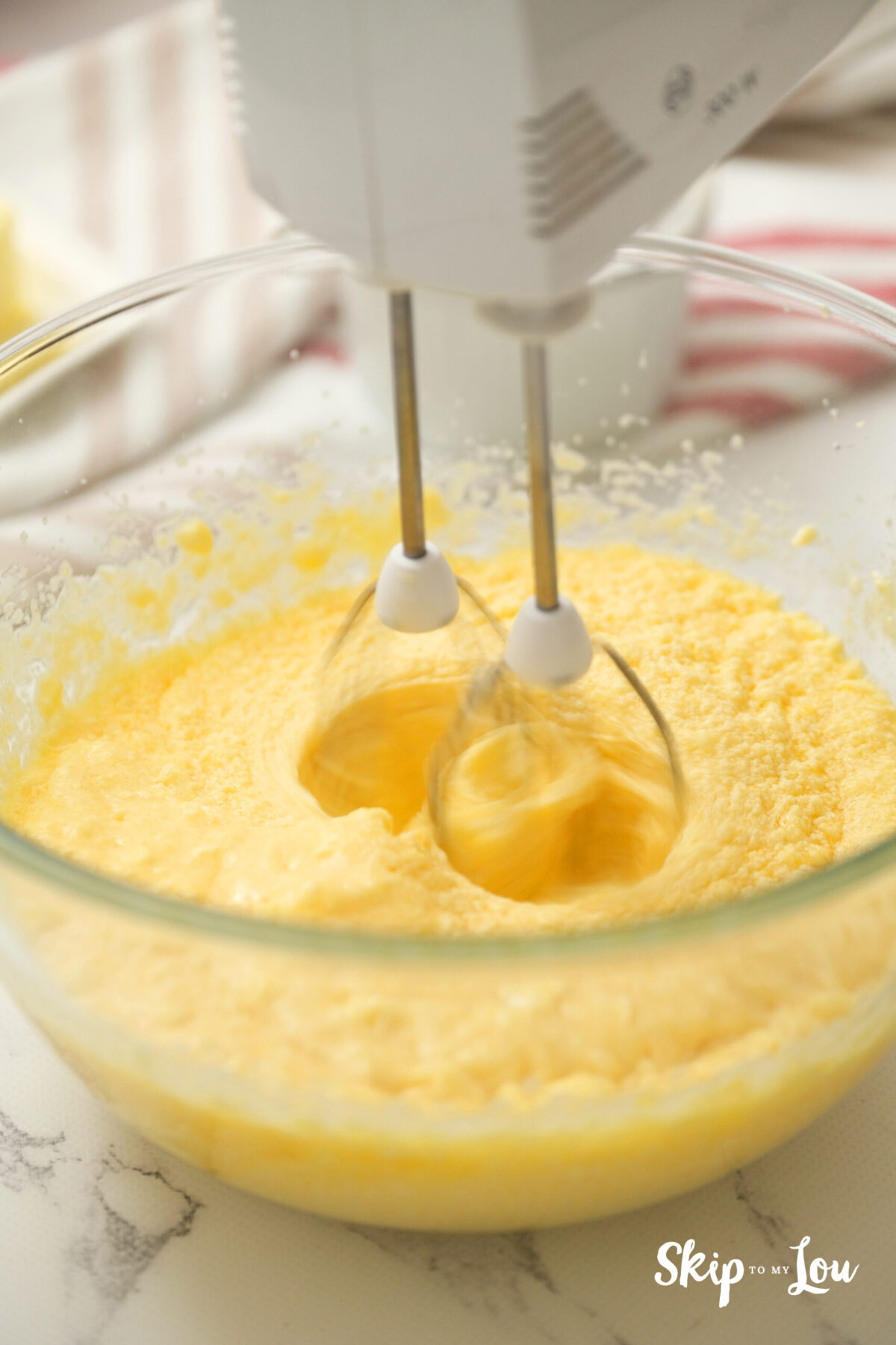 Whisking the ingredients in a bowl.