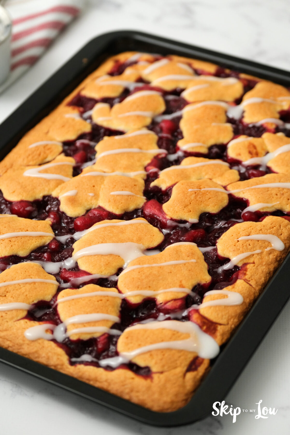 Once baked, powdered sugar mixed with milk is drizzled over the cake.