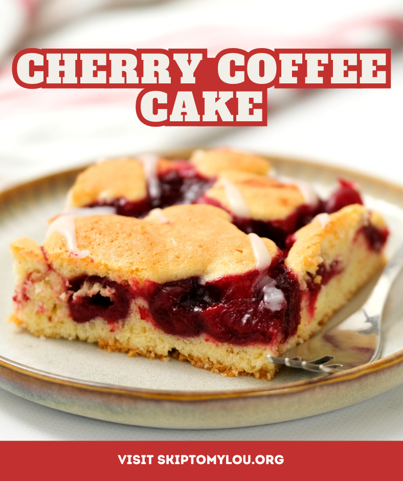 A plate with a slice of cherry coffee cake and a fork resting near it