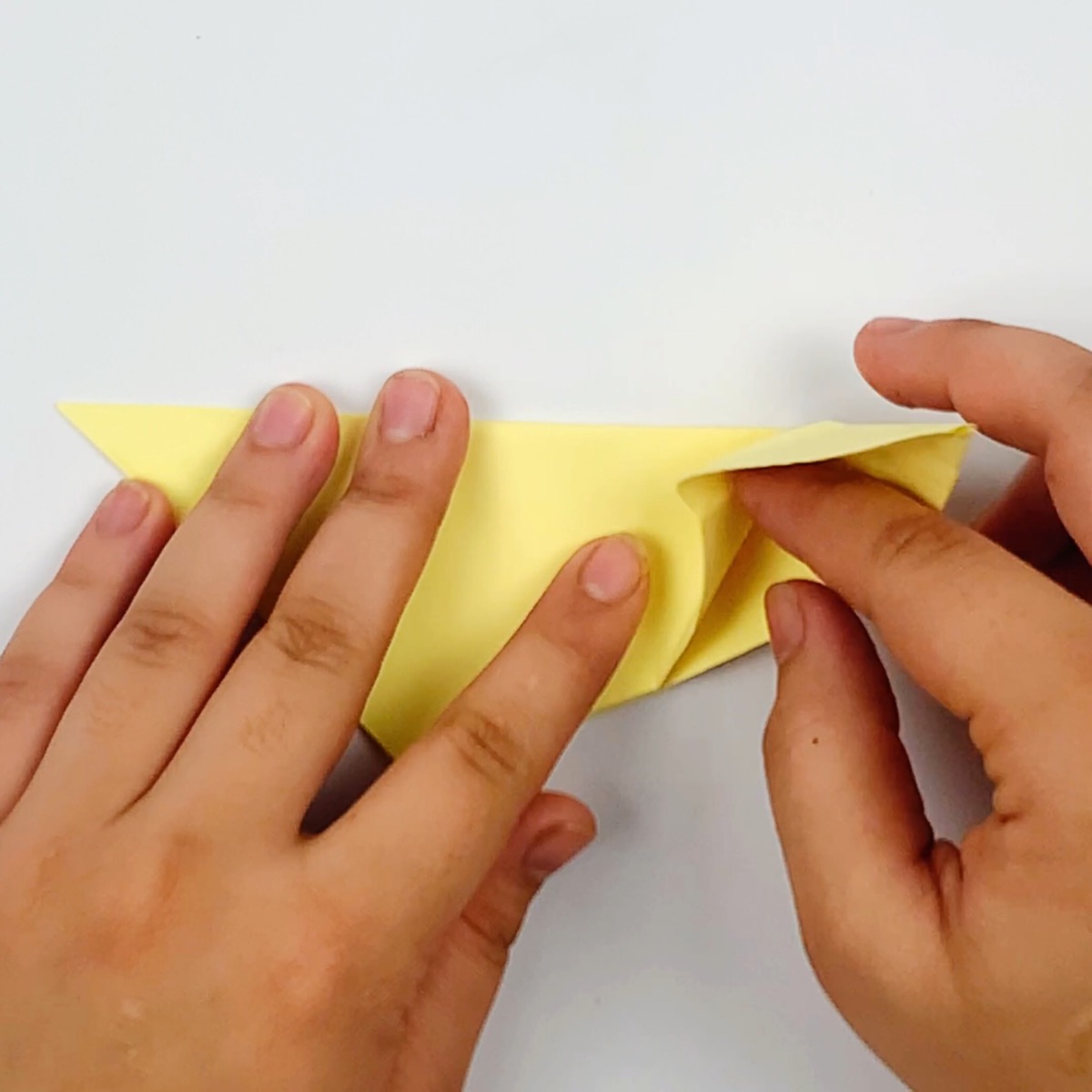Making a hole inbetween the two pieces of paper.