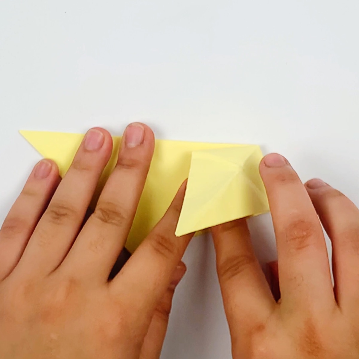Folding the tail section over again.