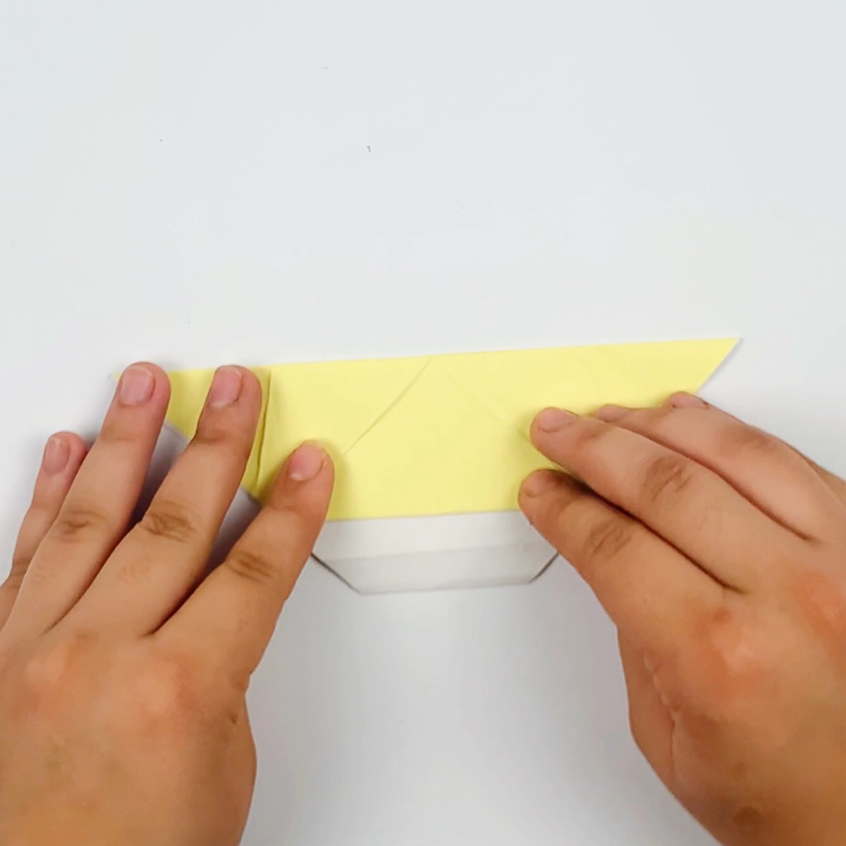 The paper folded in half from the top point.