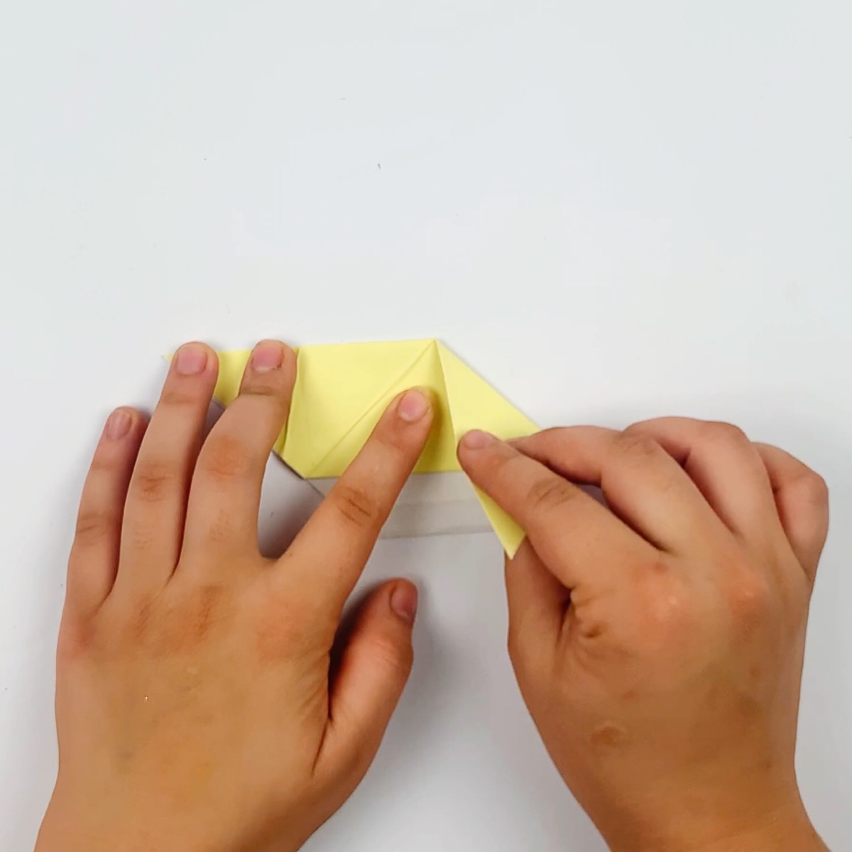 The ears of the origami cat are the next folds to make.