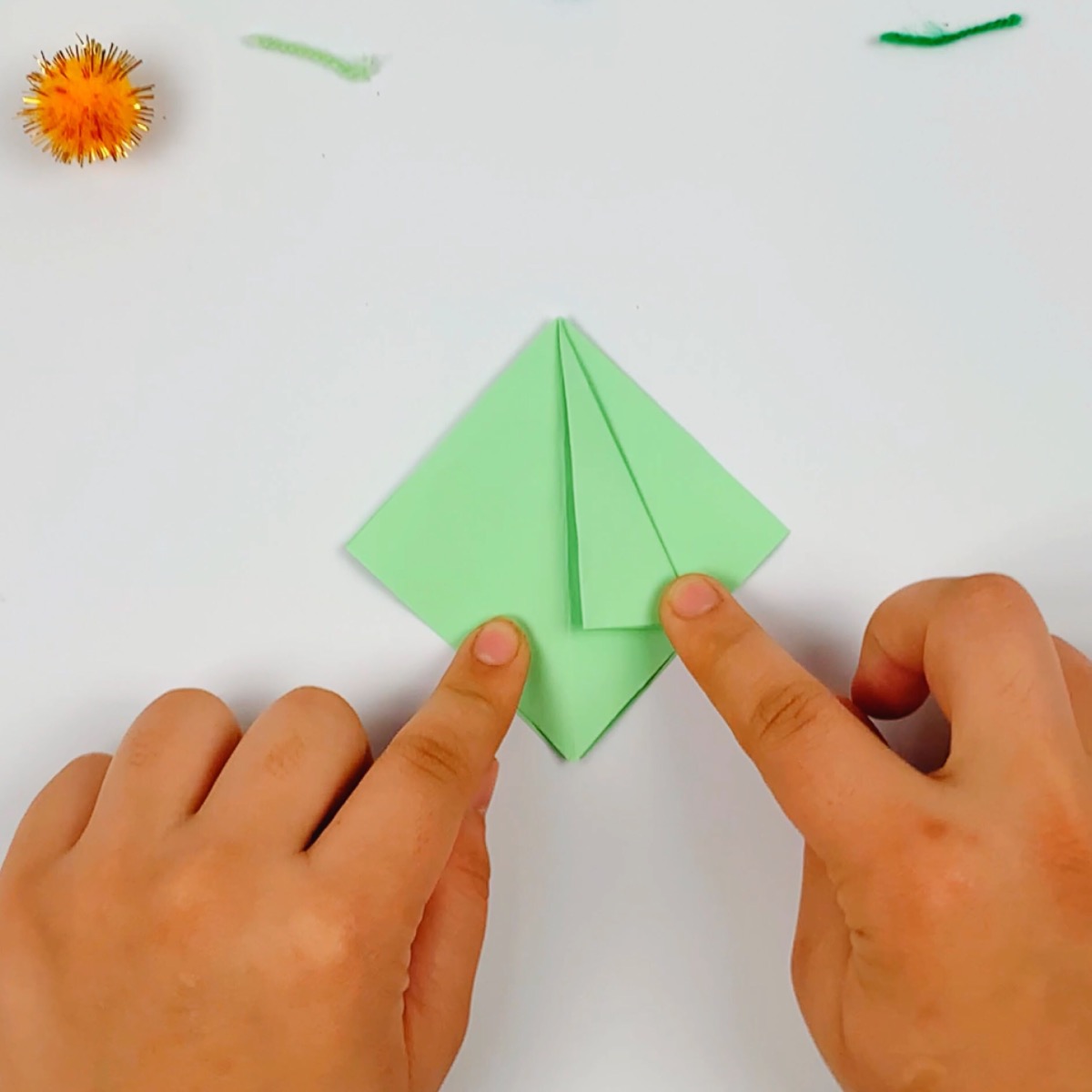 The top section of the paper on the right is folded inside to the center line.