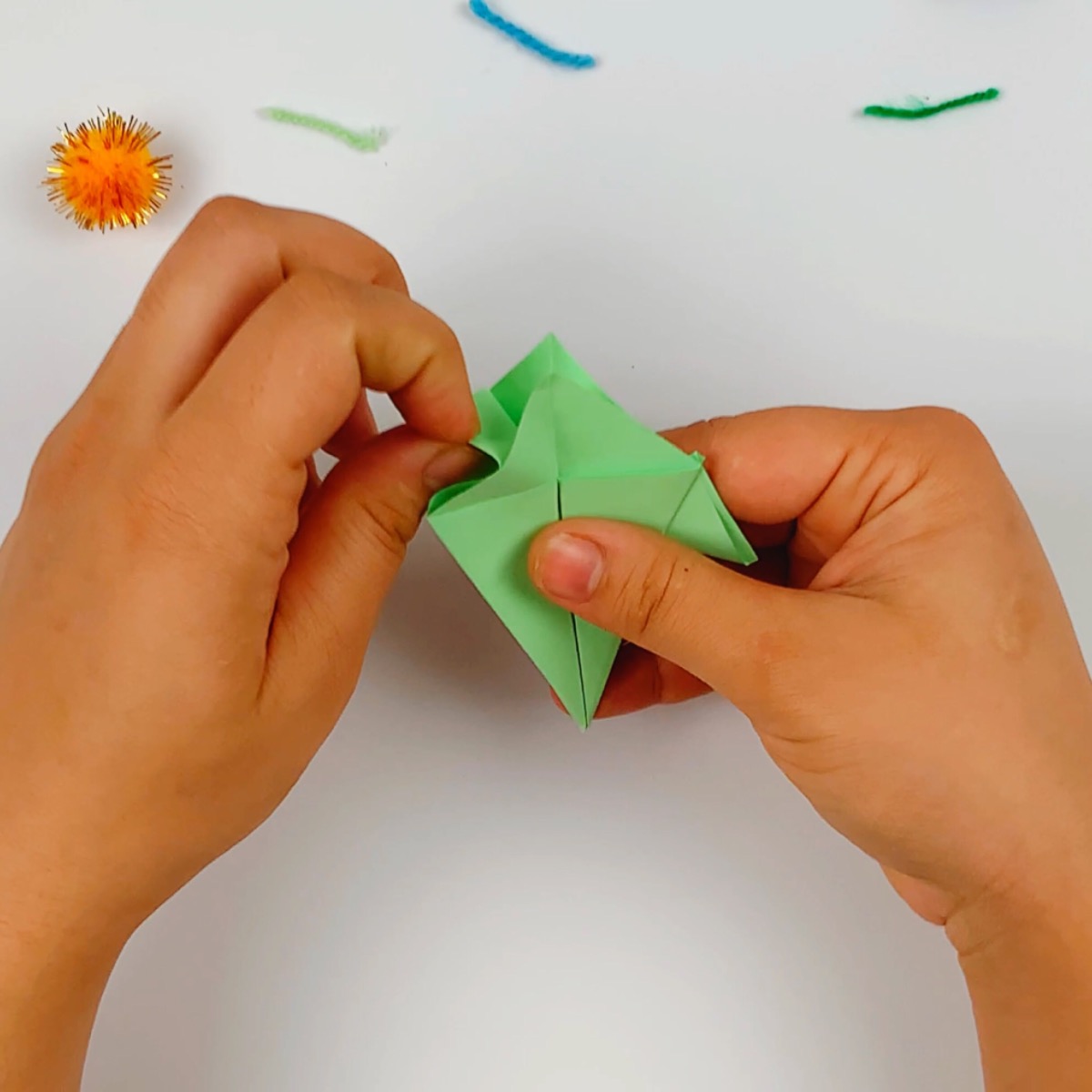 The paper is opened up and the fins are folded on the left hand side.