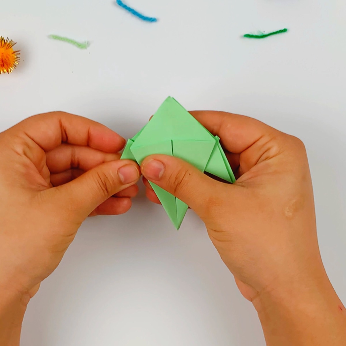 Once the fins are folded, you can clearly see the shape of the origami fish.