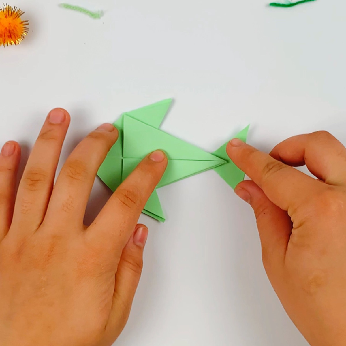 The origami fish tail is placed on body.