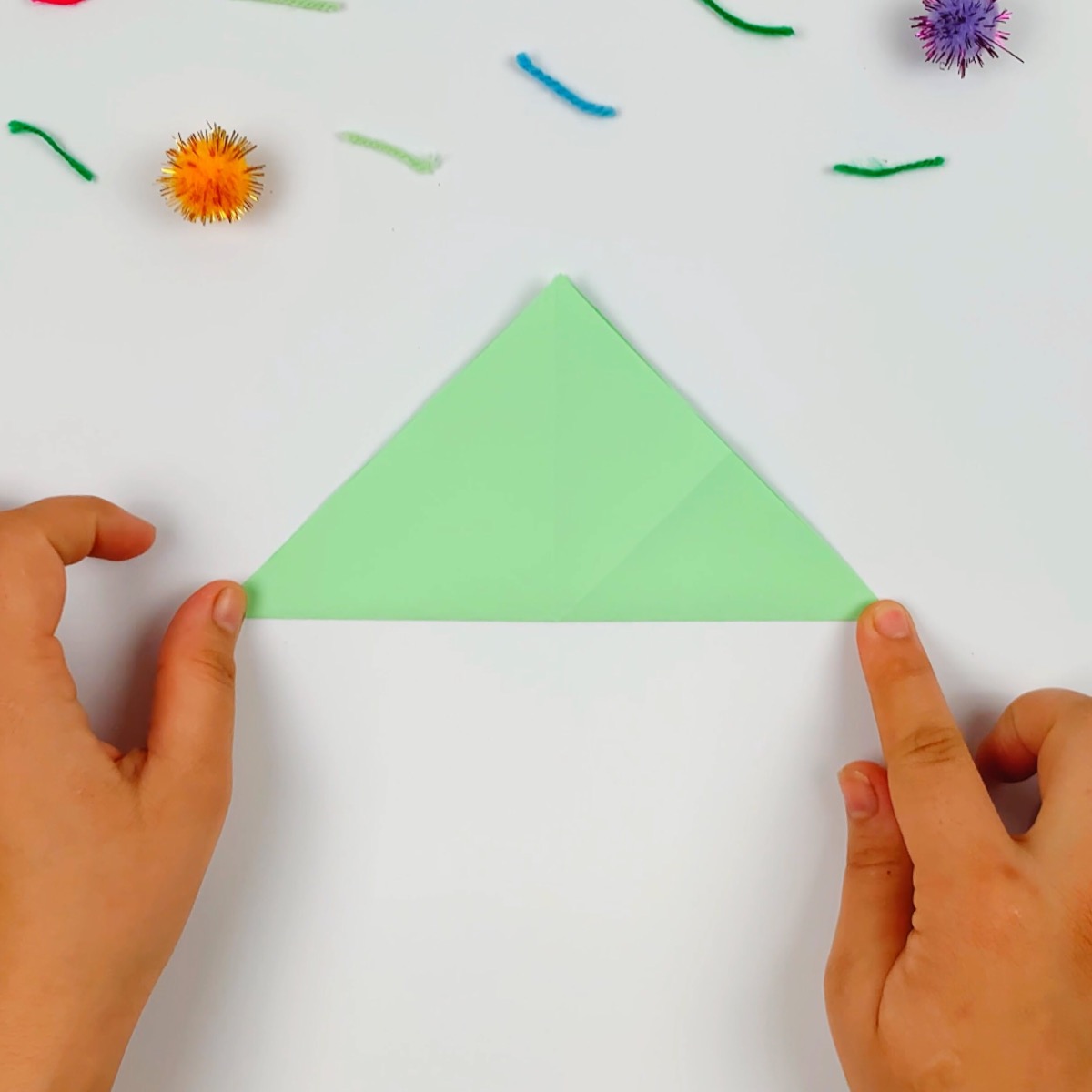 The paper in the triangle shape is flattened down.
