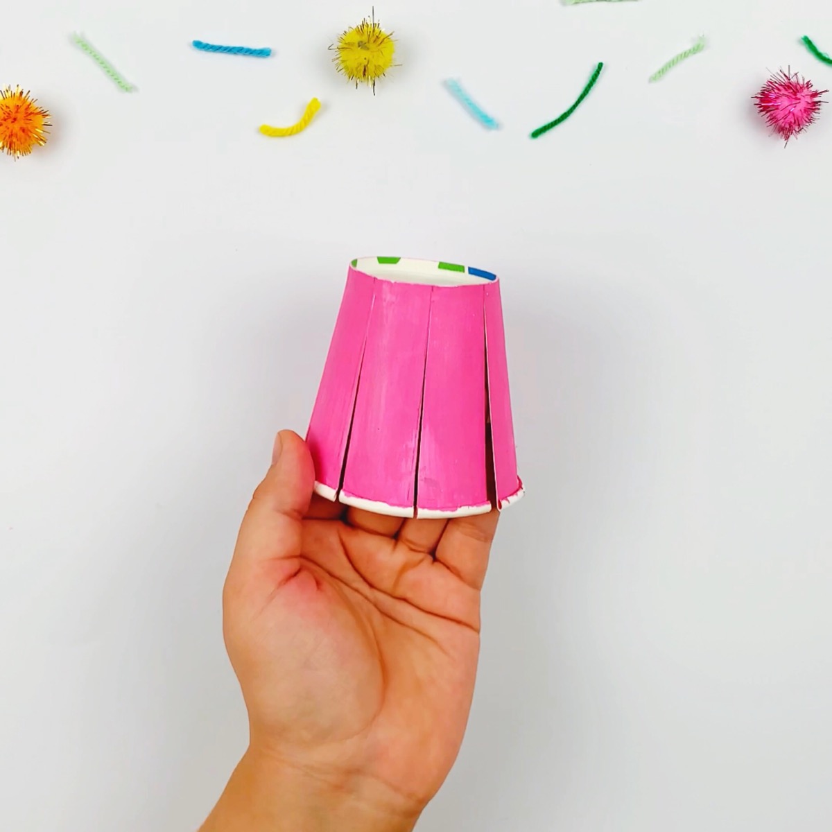 The paper cup after it has been cut into strips.