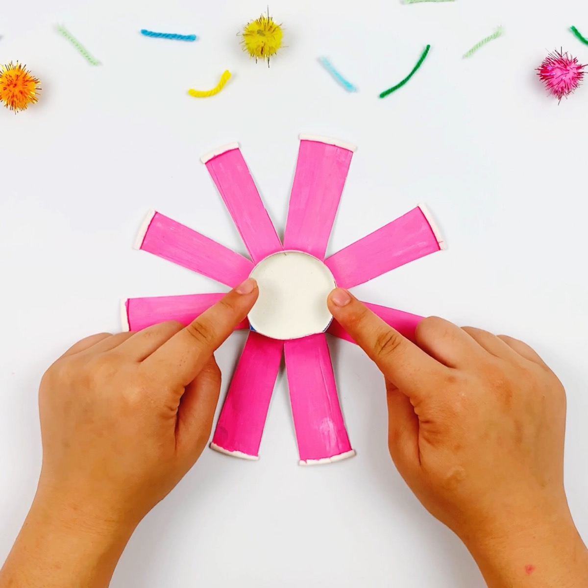 Folding out the strips of the paper cup into a flower type formation