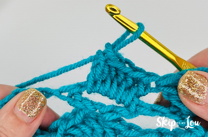 Blue colored yarn crochet in a shell stitch pattern.