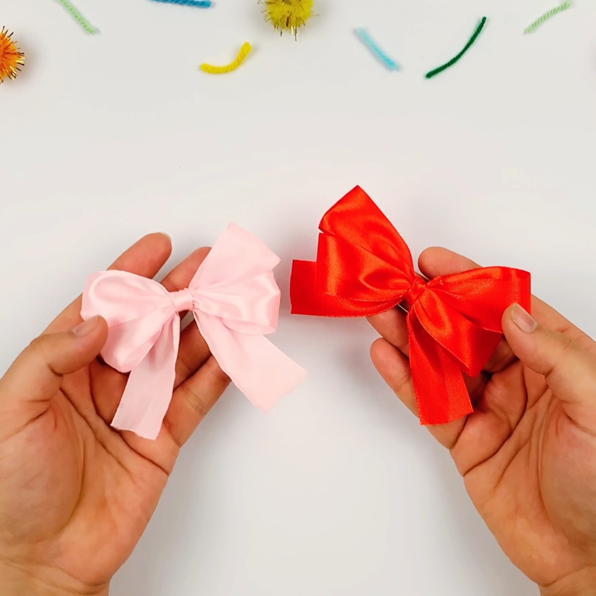 Step 12 of the ribbon bow making process showing how the ribbon is fluffed out to the perfect form.