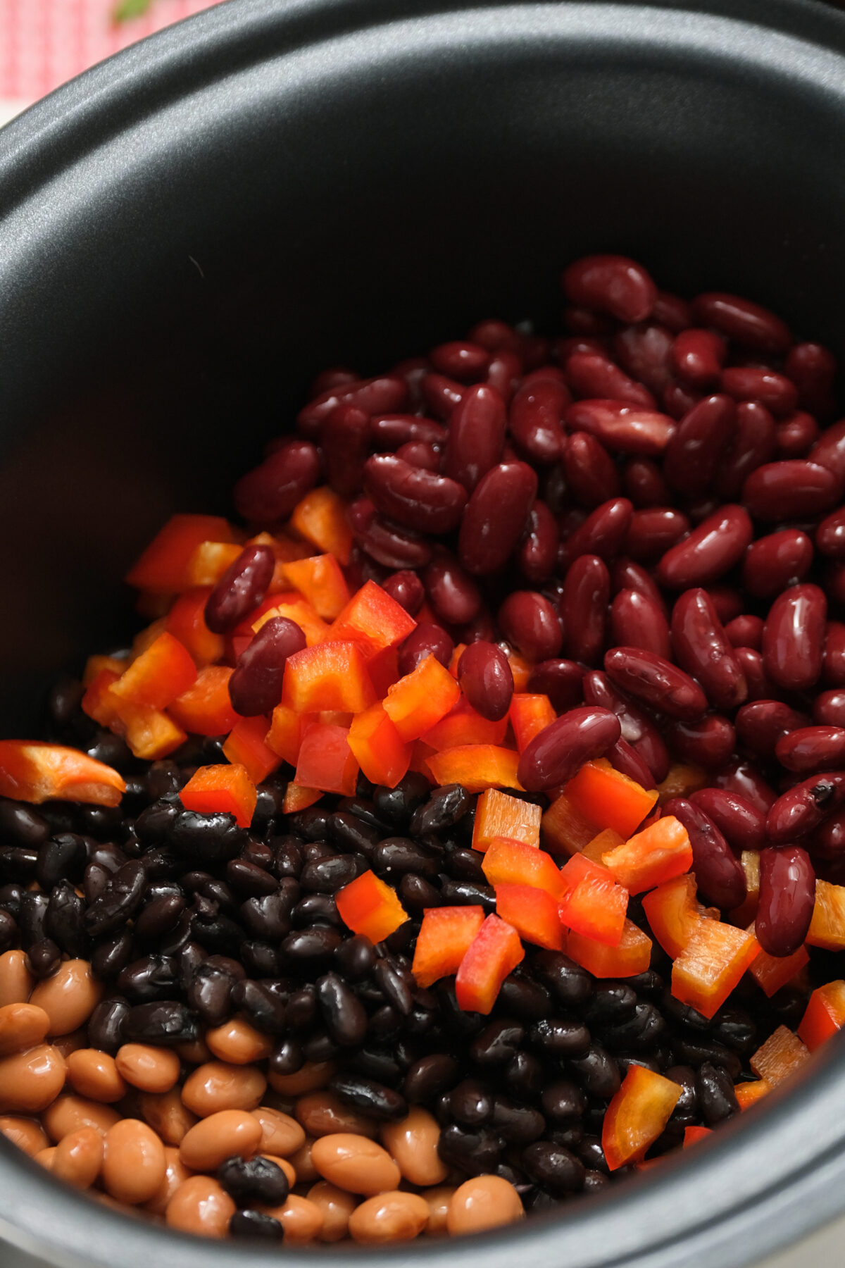 The start of the vegetarian chili process includes pinto, black and kidney beans