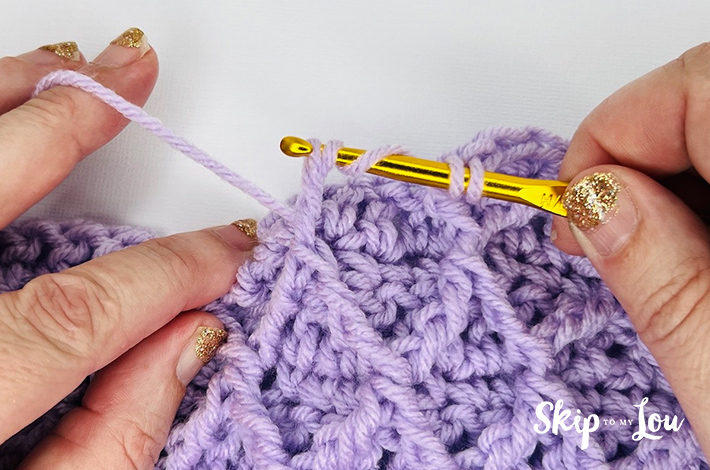 Step 2.4 – Pull yarn through two loops leaving five stitches