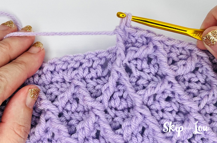 Step 1.6 – Yarn over and pull through first two loops, leaving two loops 