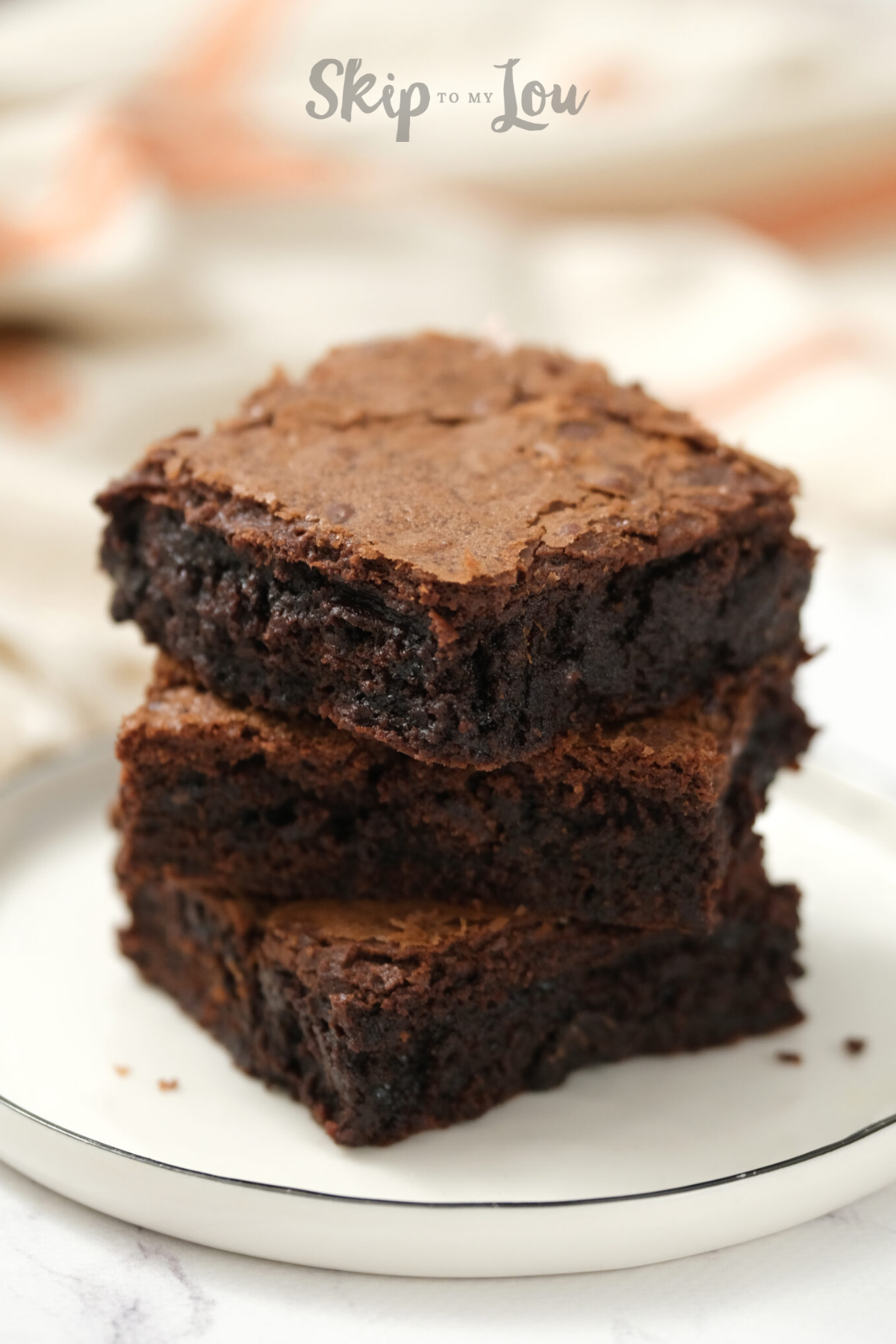 Chocolate brownie on a white plate made from Skip to My Lou's easy brownie recipe.