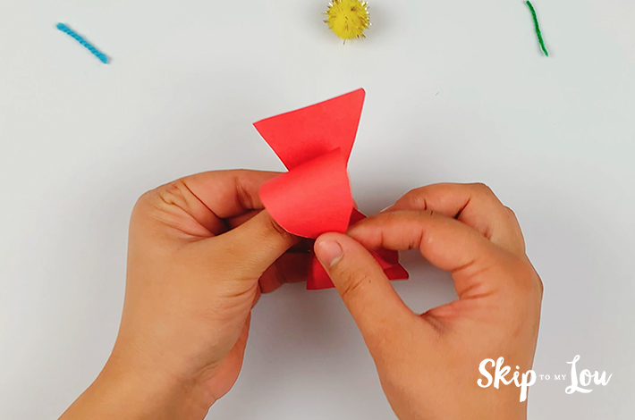 The bow tie shape is formed by pushing down on the center crease. 