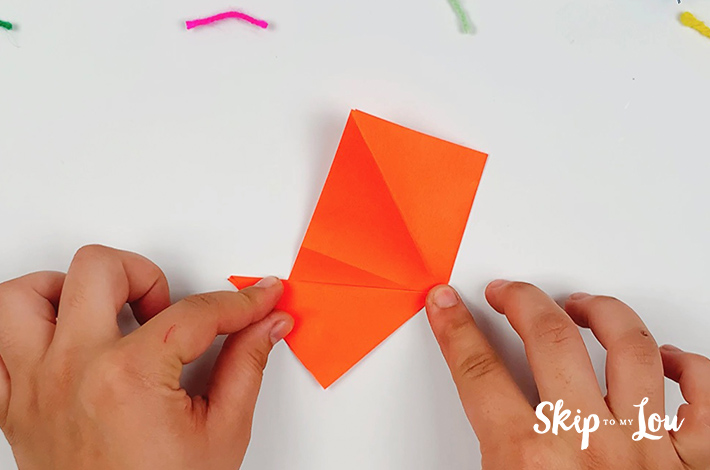 The paper is folded to form a small triangle at the bottom.