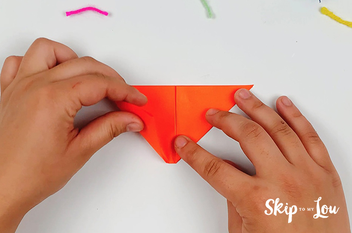 The bottom left is also folded towards the top center to form a 45-degree angle.
