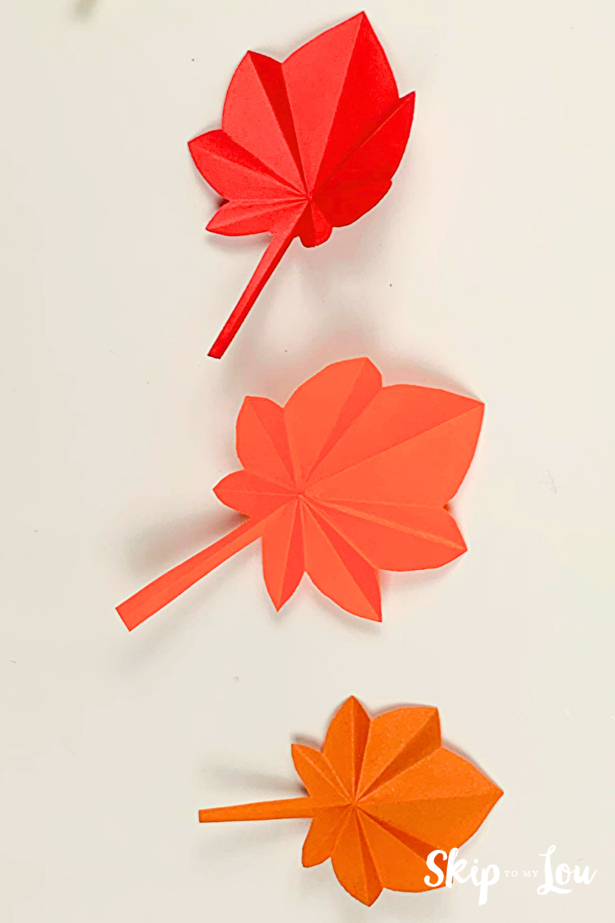 Orange origami leaf on a cream background from Skip to my Lou.