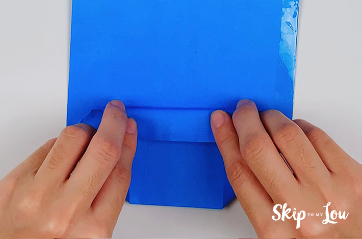 The bottom and top parts of this lower section of the origami shirt and tie are folded over.