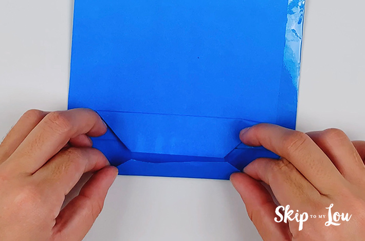 The bottom and top parts of this lower section of the origami shirt and tie are folded over.