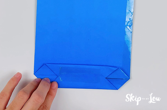 The bottom and top parts of this lower section of the origami shirt and tie are stuck with clear tape.