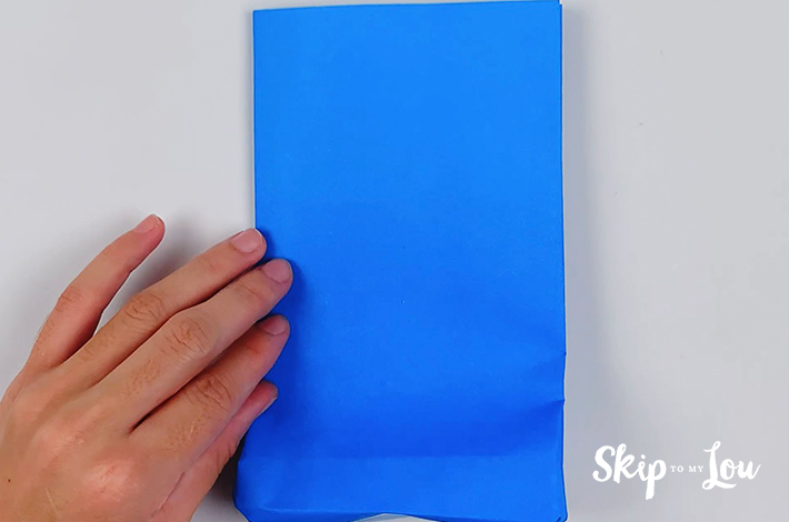 The paper for the origami shirt and tie is once again flattened.