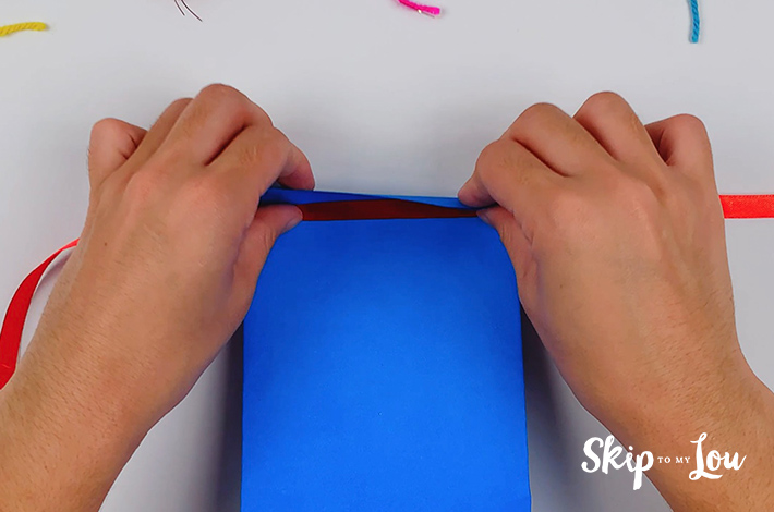 The top of the paper is folded over the ribbon.