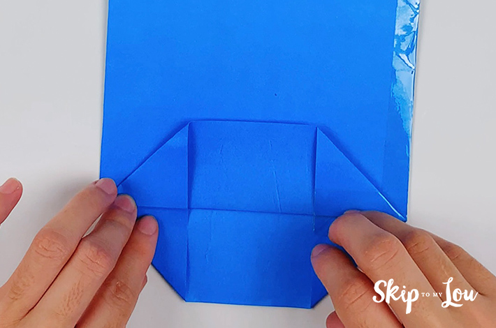 The bottom and top parts of this lower section of the origami shirt and tie are folded over.