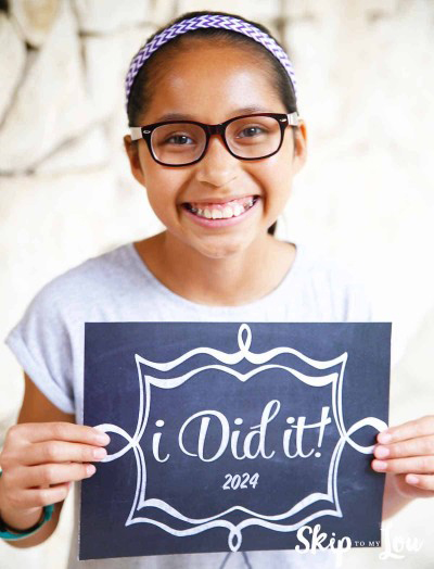Child holding an "I Did It 2024" sign for the end of the school year from Skip to My Lou