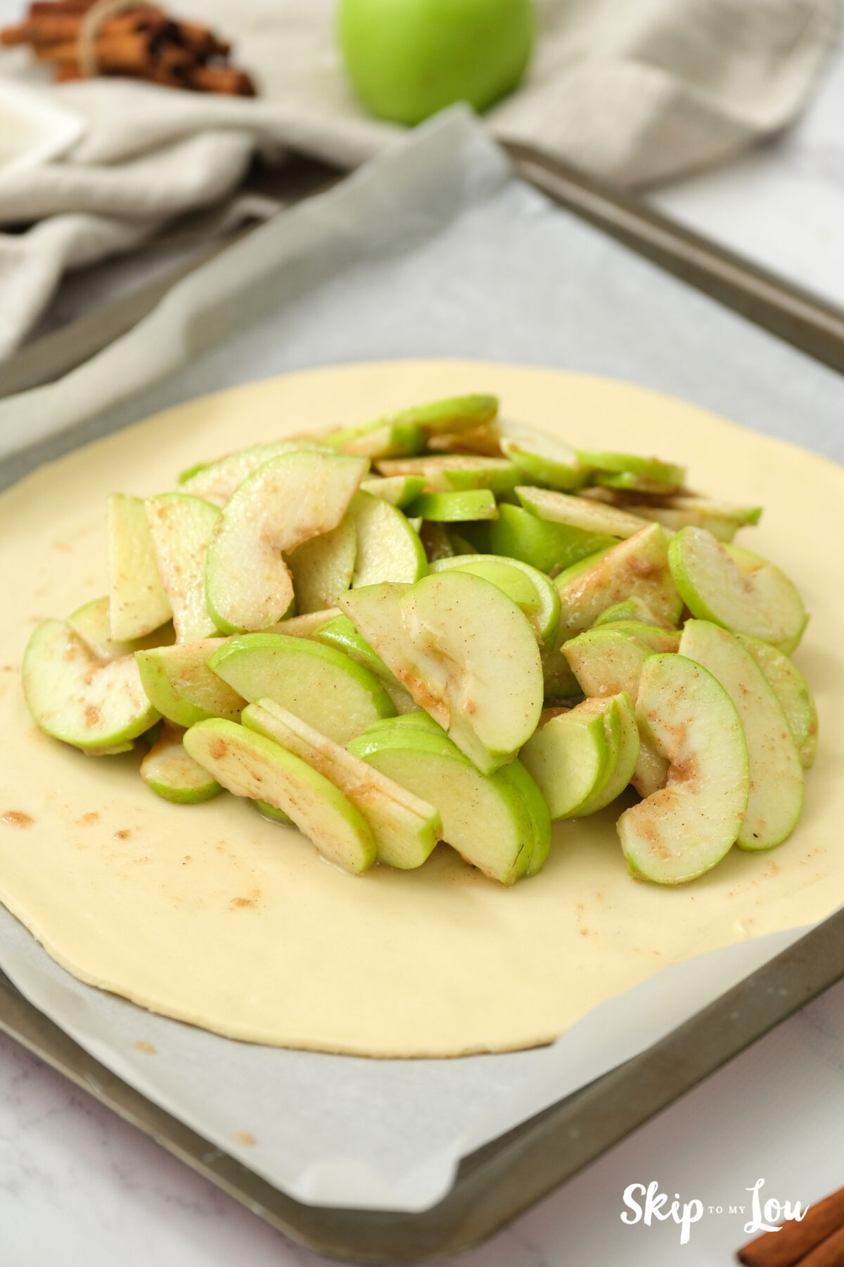 Apple mixture placed on a round pastry disk.