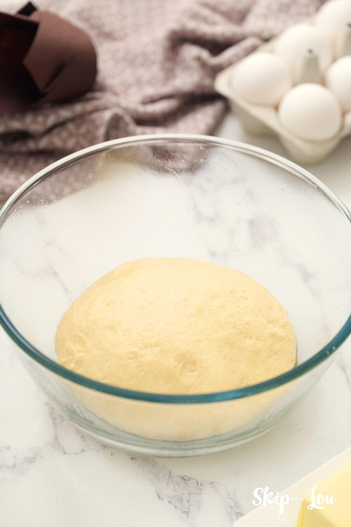 A bowl with dough, resting to allow it to rise.