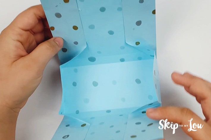 Two hands bringing the top and bottom sections together.