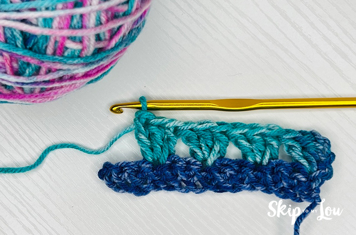 Step 2.2 – Miss two stitches, then make 3 treble crochets and repeat.