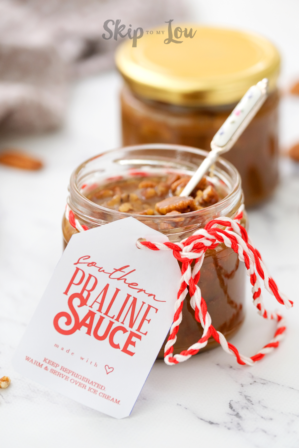 A mason jar filled with southern praline sauce made from a recipe from Skip to my Lou.