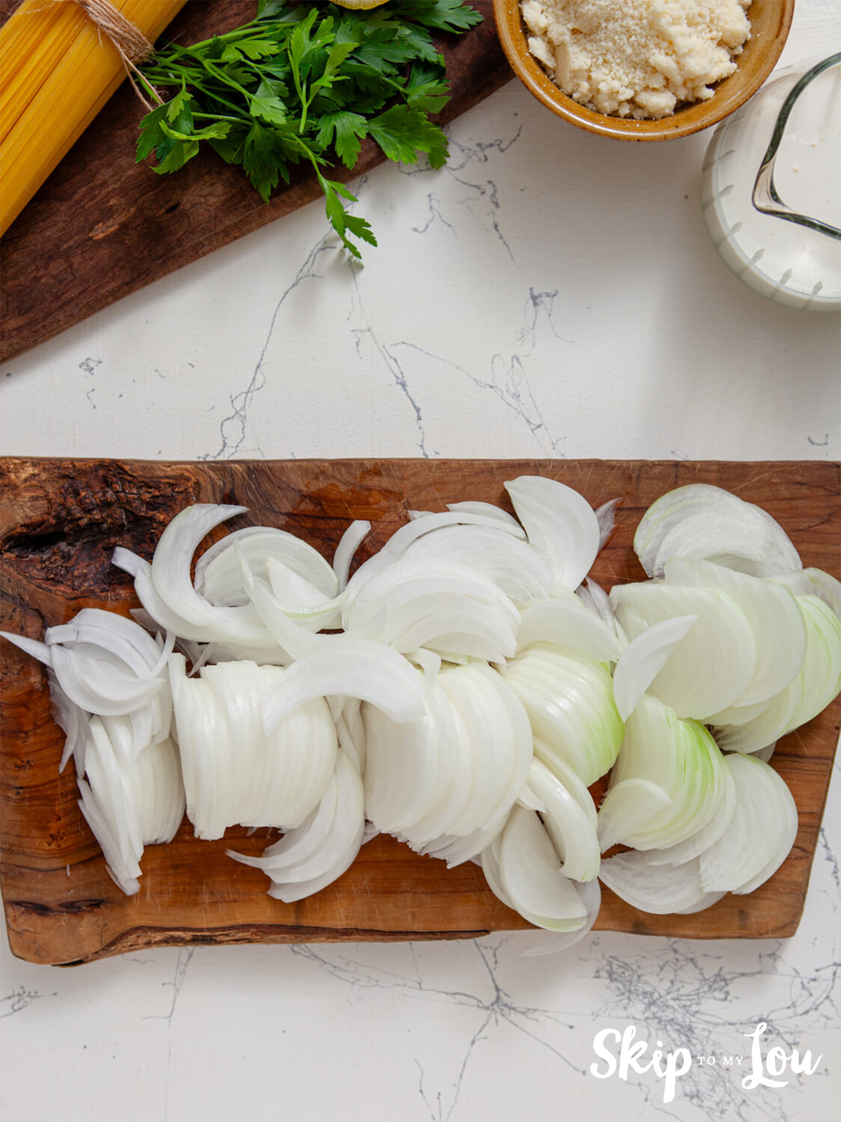 Sliced onions on a cutting board.