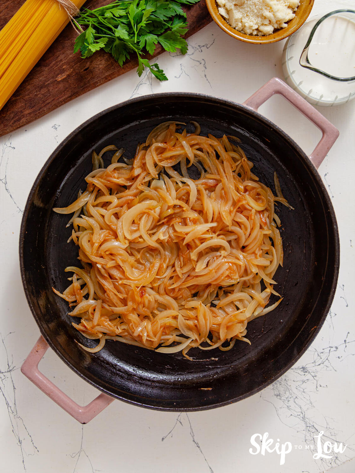 Onions frying in a skillet.