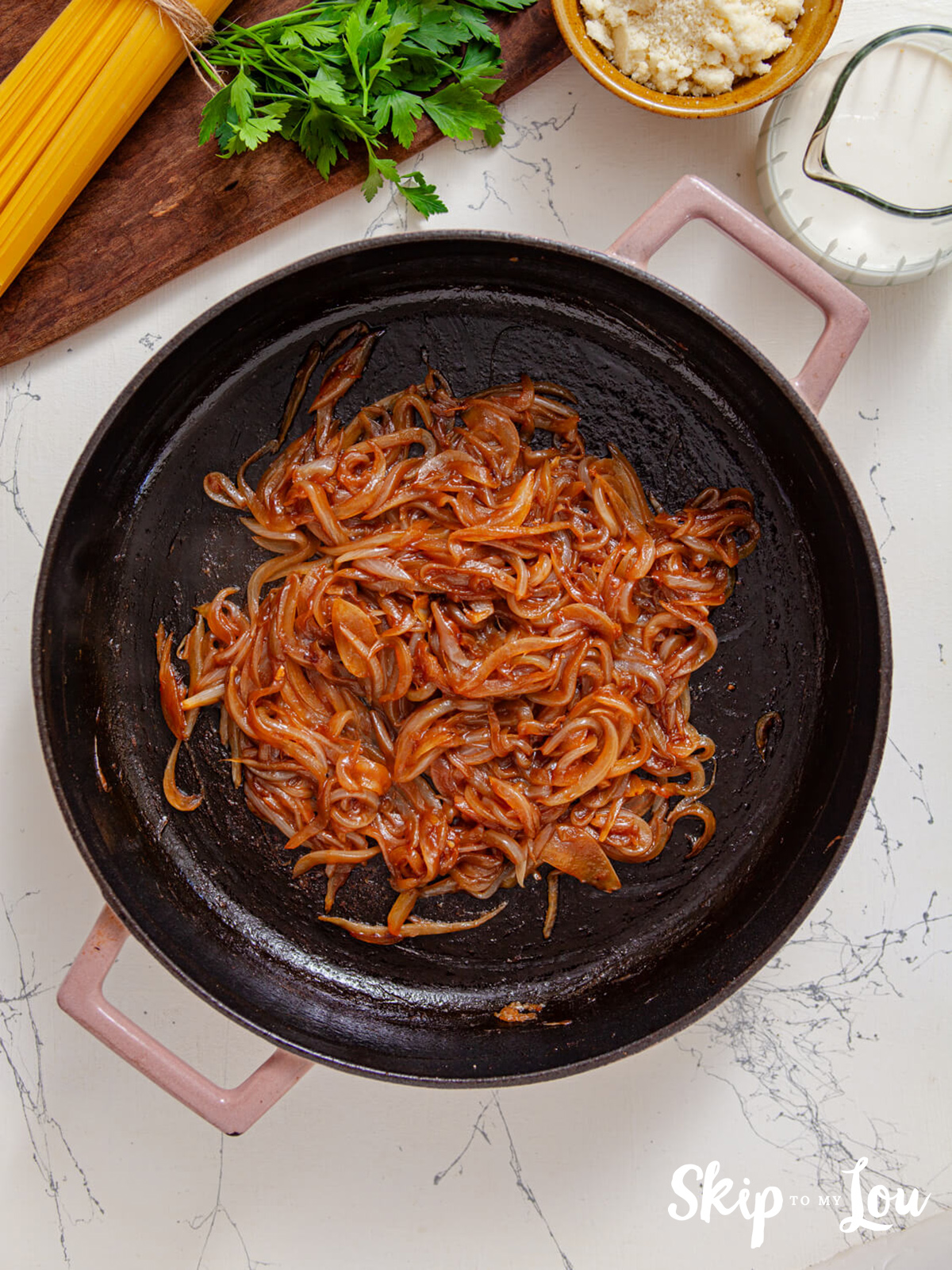 Caramelized. onions frying in a skillet.