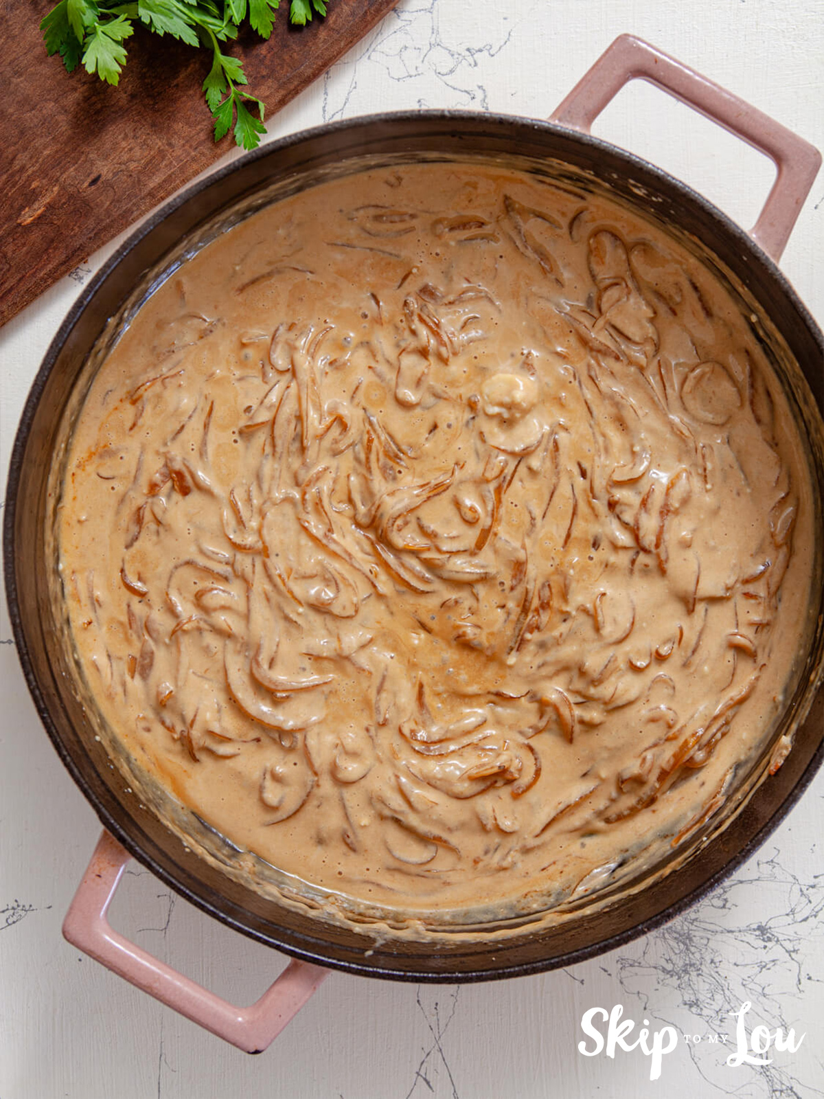 A skillet with caramelized onions with cream, parmesan and lemon well stirred through.