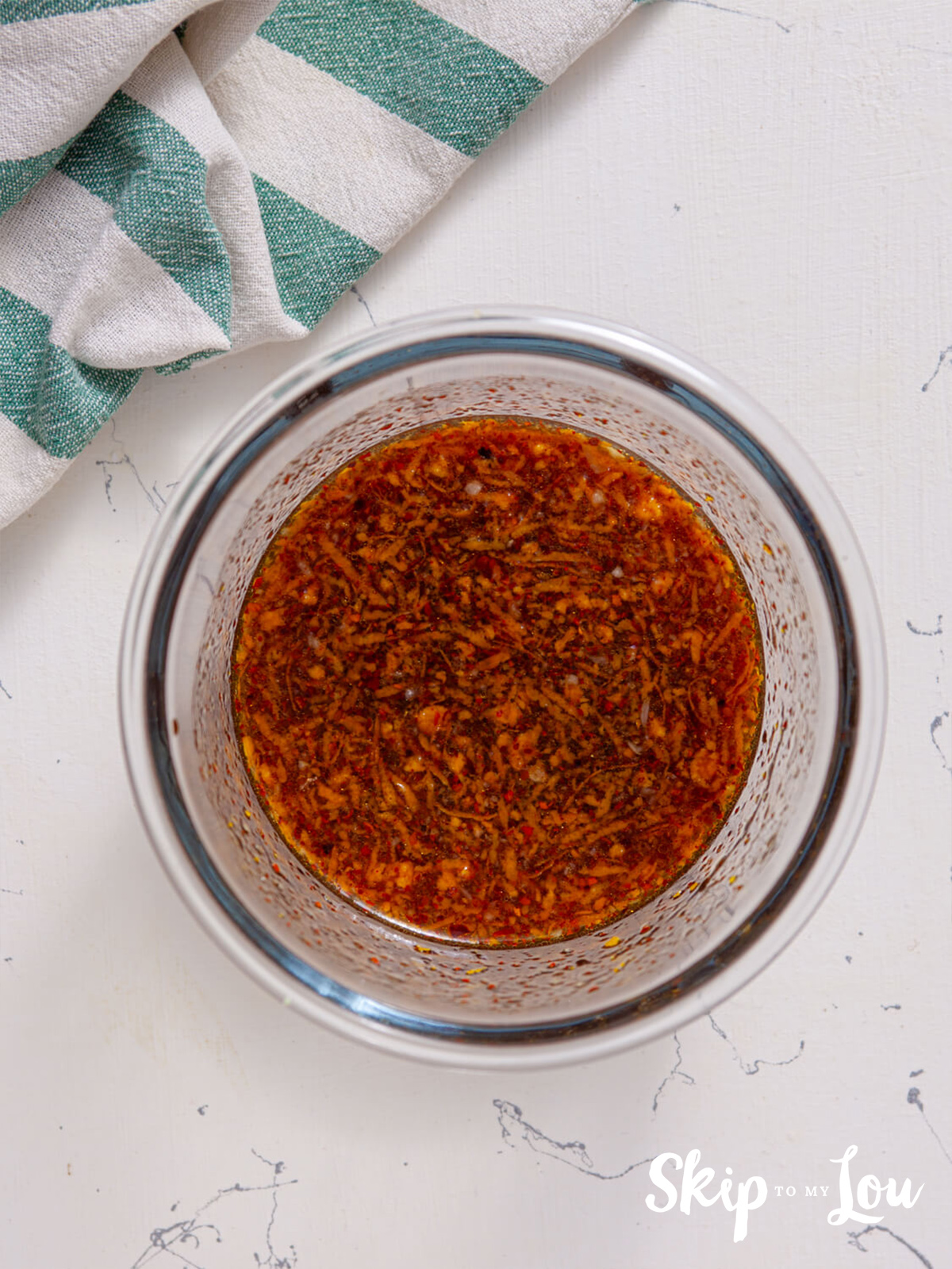 Honey, orange juice, sugar, soy sauce, rice vinegar, sesame oil, garlic, orange zest, and red chili flakes combined in a bowl. 