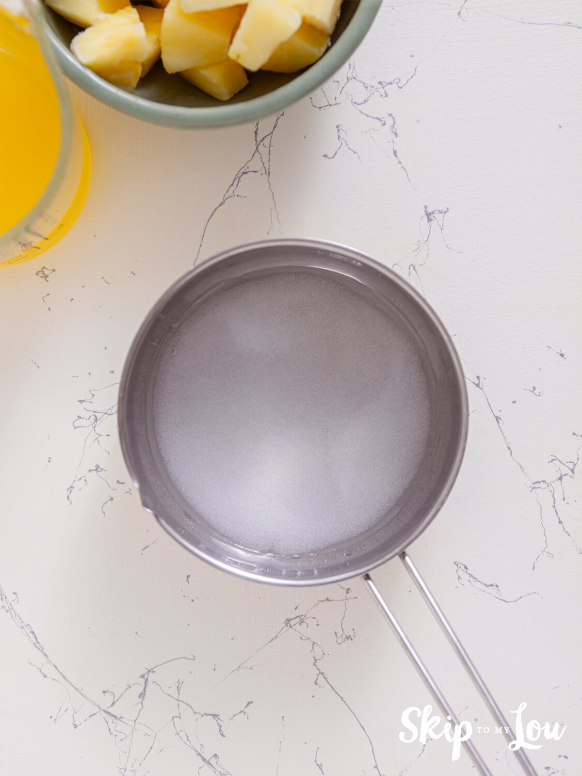 All the ingredients for the sugar free simple syrup being boiled in a skillet for 4 to 5 minutes.