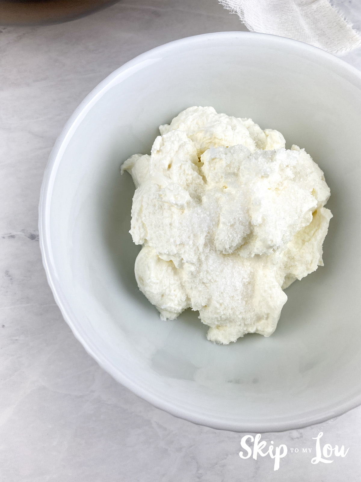 Greek yogurt in a bowl with salt on top.