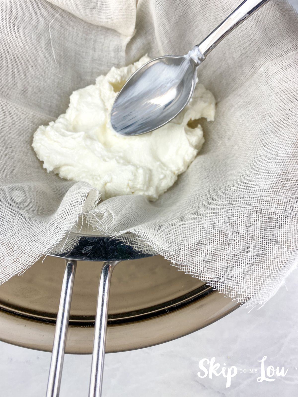 Greek yogurt in a strainer, after which it is placed in a fridge for 2-3 days to drain all the liquid.
