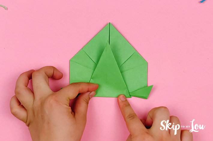 Two hands folding the bottom triangle upwards,