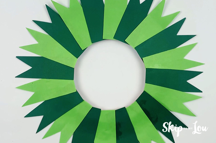 The paper plate with all the petals glued right around it.