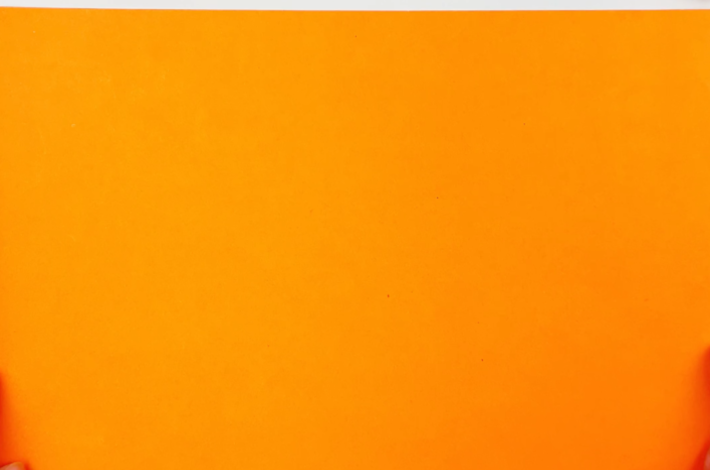 A square piece of orange paper.