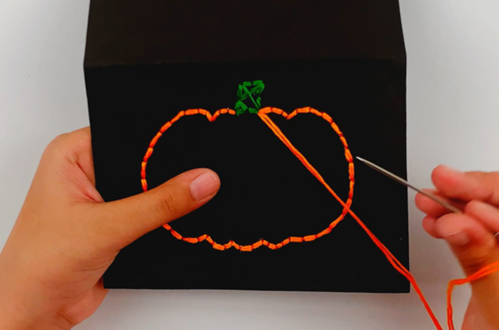 The completed pumpkin outline made from the orange string. 