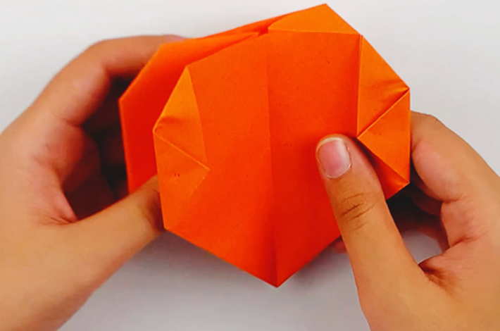 Two hands opening the paper up. 