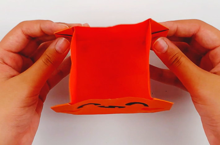 Two hands holding the open gift bag.